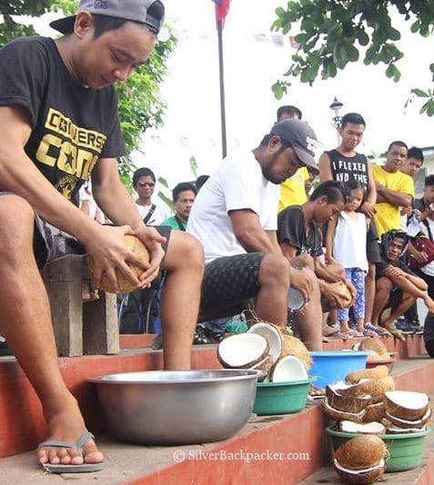 cracking coconuts at tabak festival tilad paga